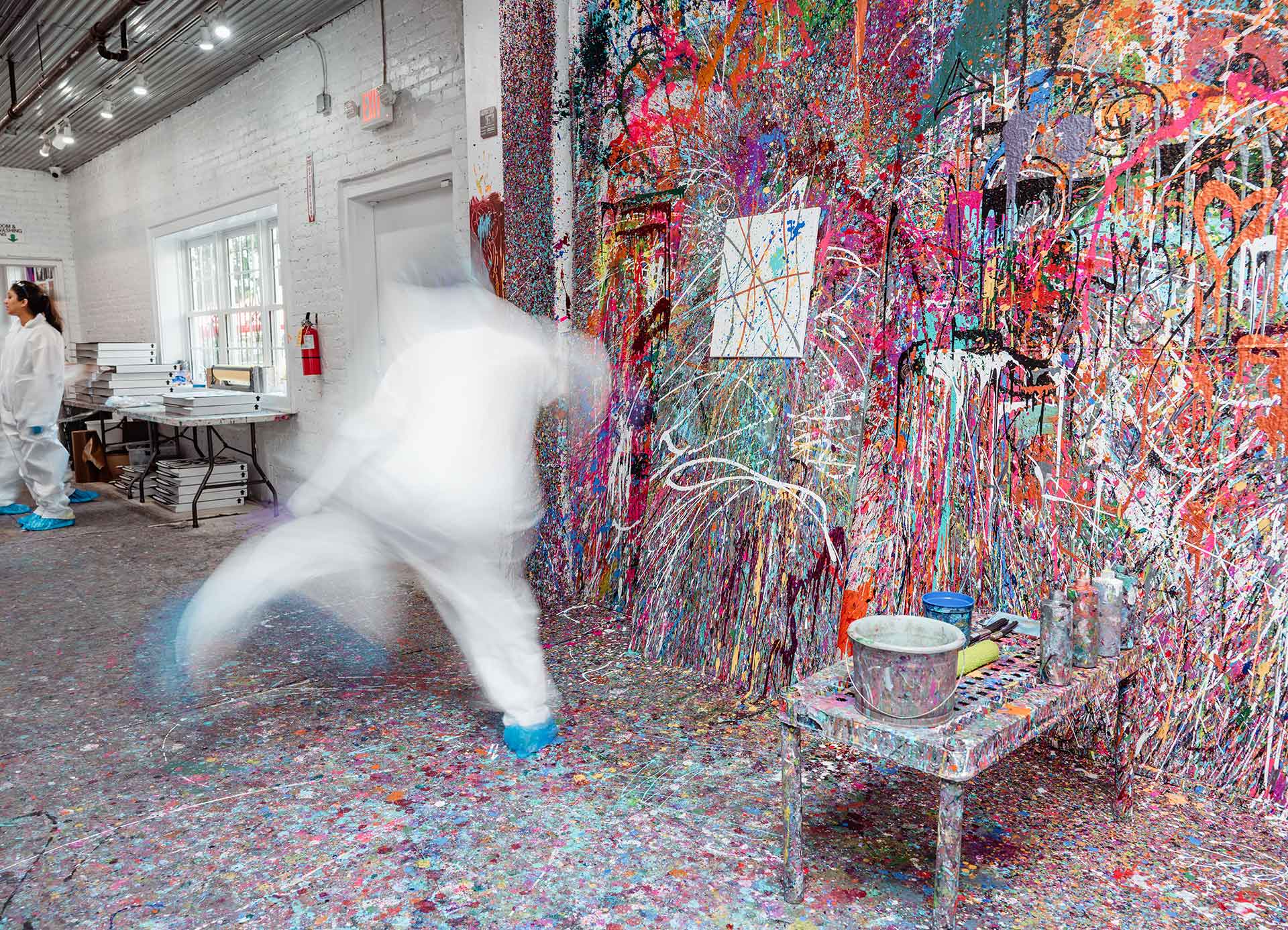 Customer throwing paint at a canvas